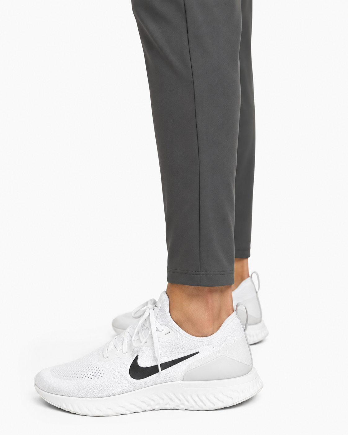 Gray joggers worn with white sneakers, tapered leg and cuffed hem