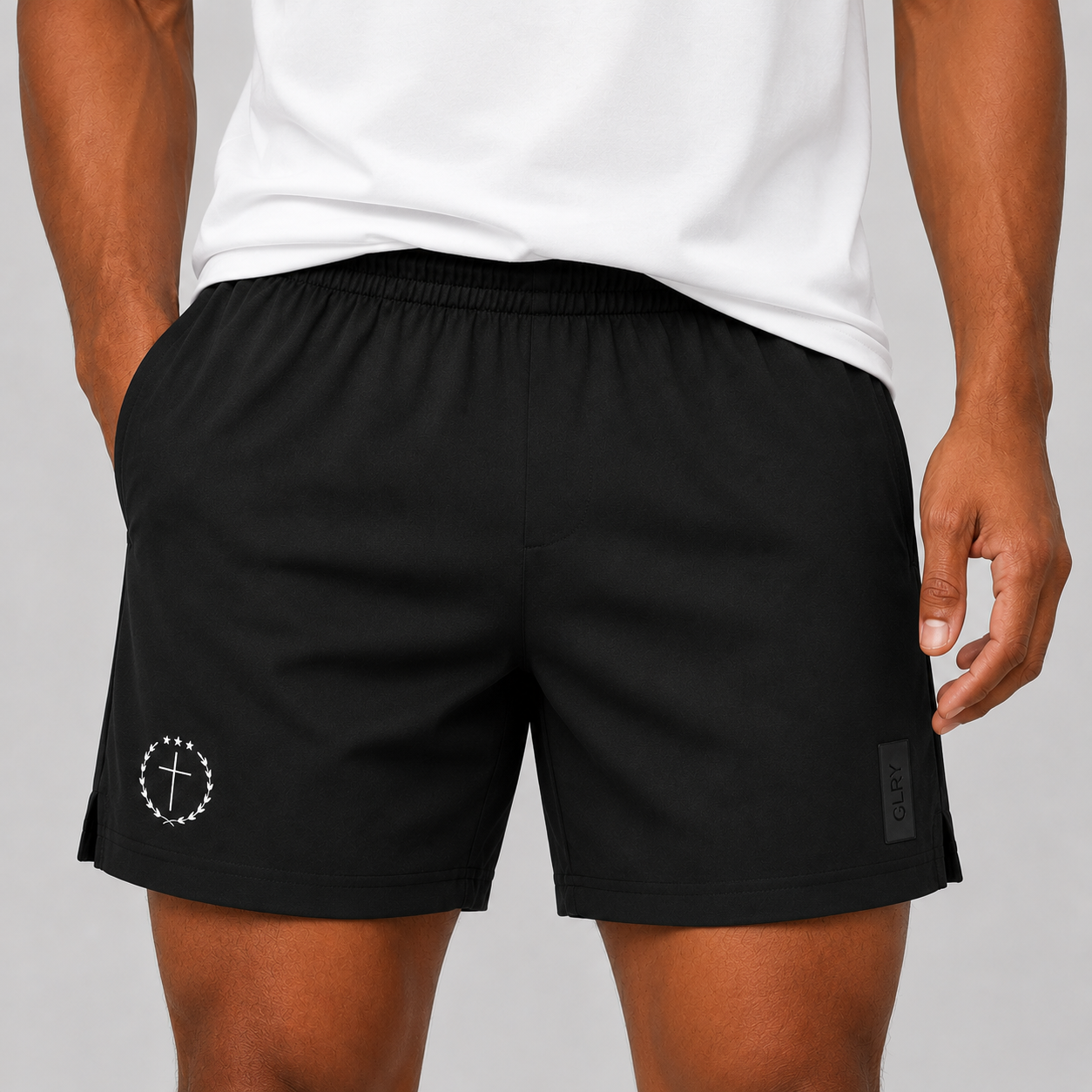 Black 5-inch shorts worn front view, elastic waist, drawstring, logo patch