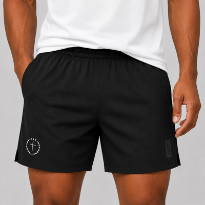 Black 5-inch shorts worn front view, elastic waist, drawstring, logo patch