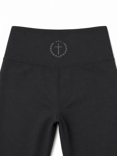 Black leggings with waistband logo and side seam detail, full length