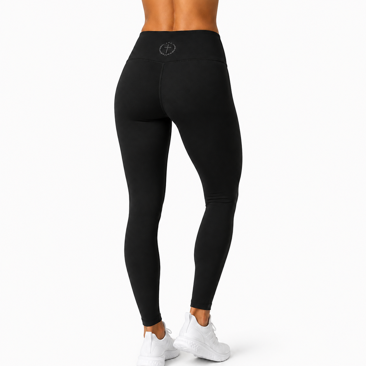 Black leggings on model, tapered fit with waistband logo at center