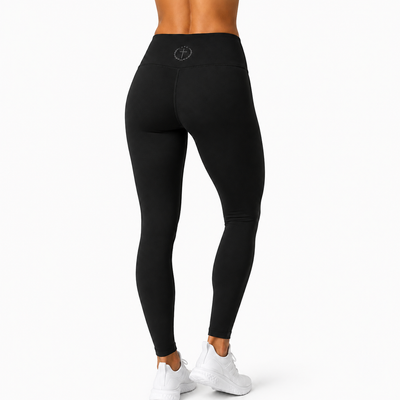 Black leggings on model, tapered fit with waistband logo at center