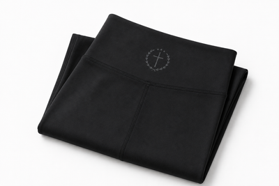 Folded black leggings with small waistband logo, full length